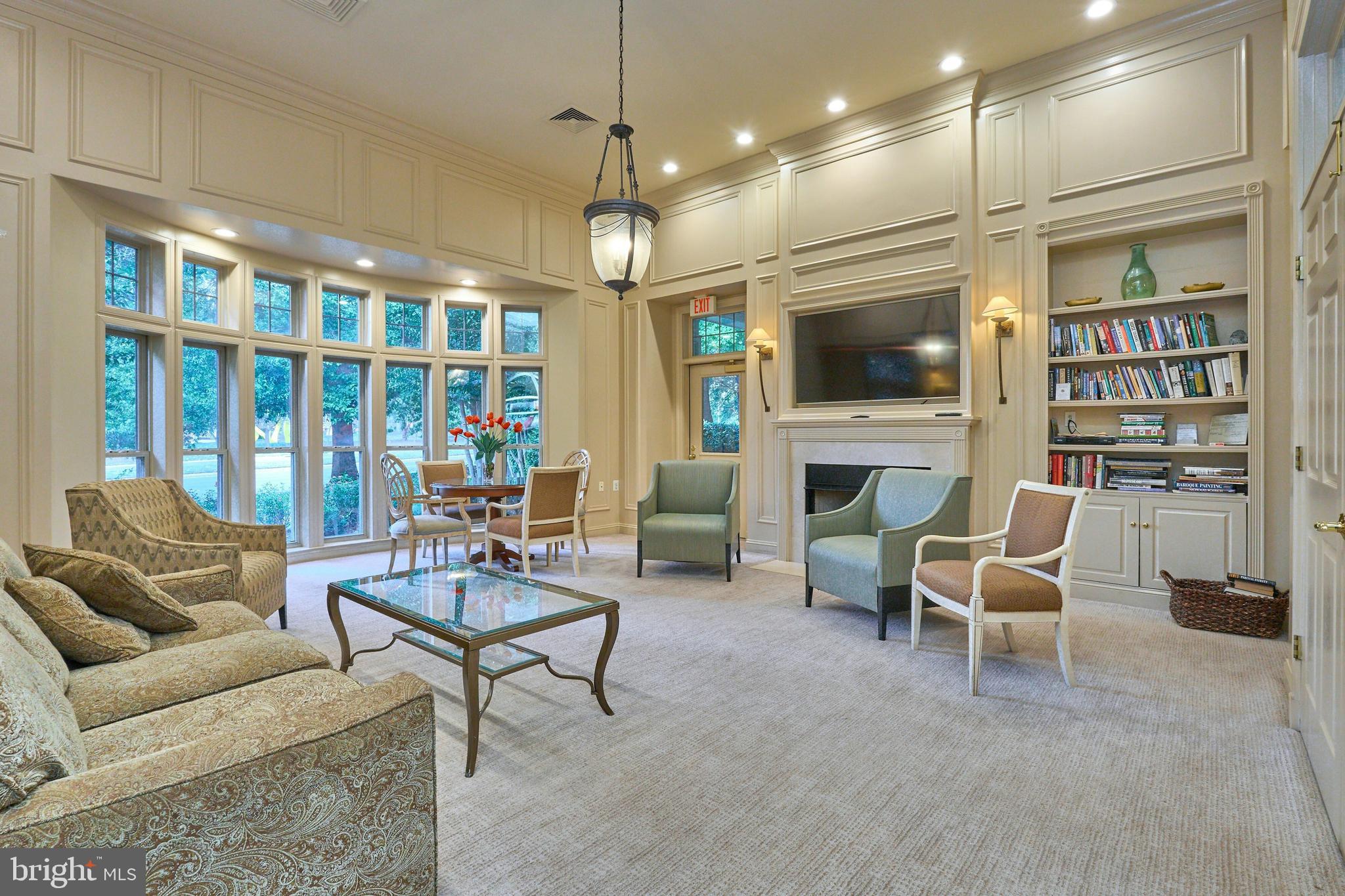 1851 Stratford Park Place, Unit 212 Reston, VA 20190 - Photo 29 of 40 a living room with furniture a flat screen tv and a fireplace