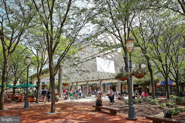 a front view of a building with trees all around