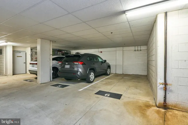 a view of a cars park in front of a building