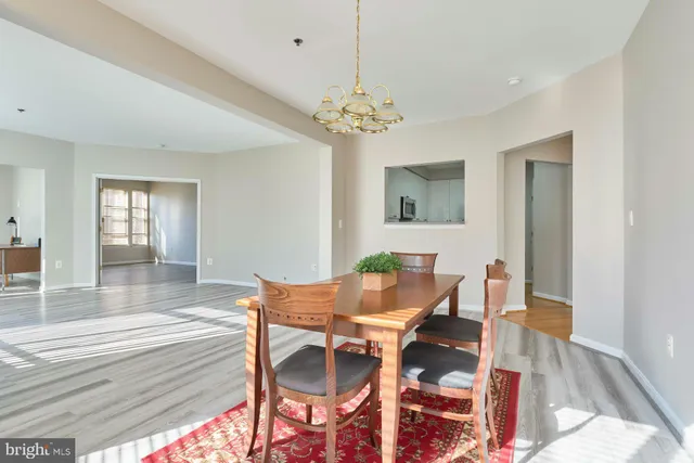 a view of a dining room with furniture and chandelier