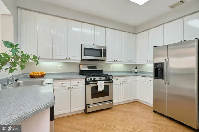 a kitchen with a white stove top oven and white cabinets