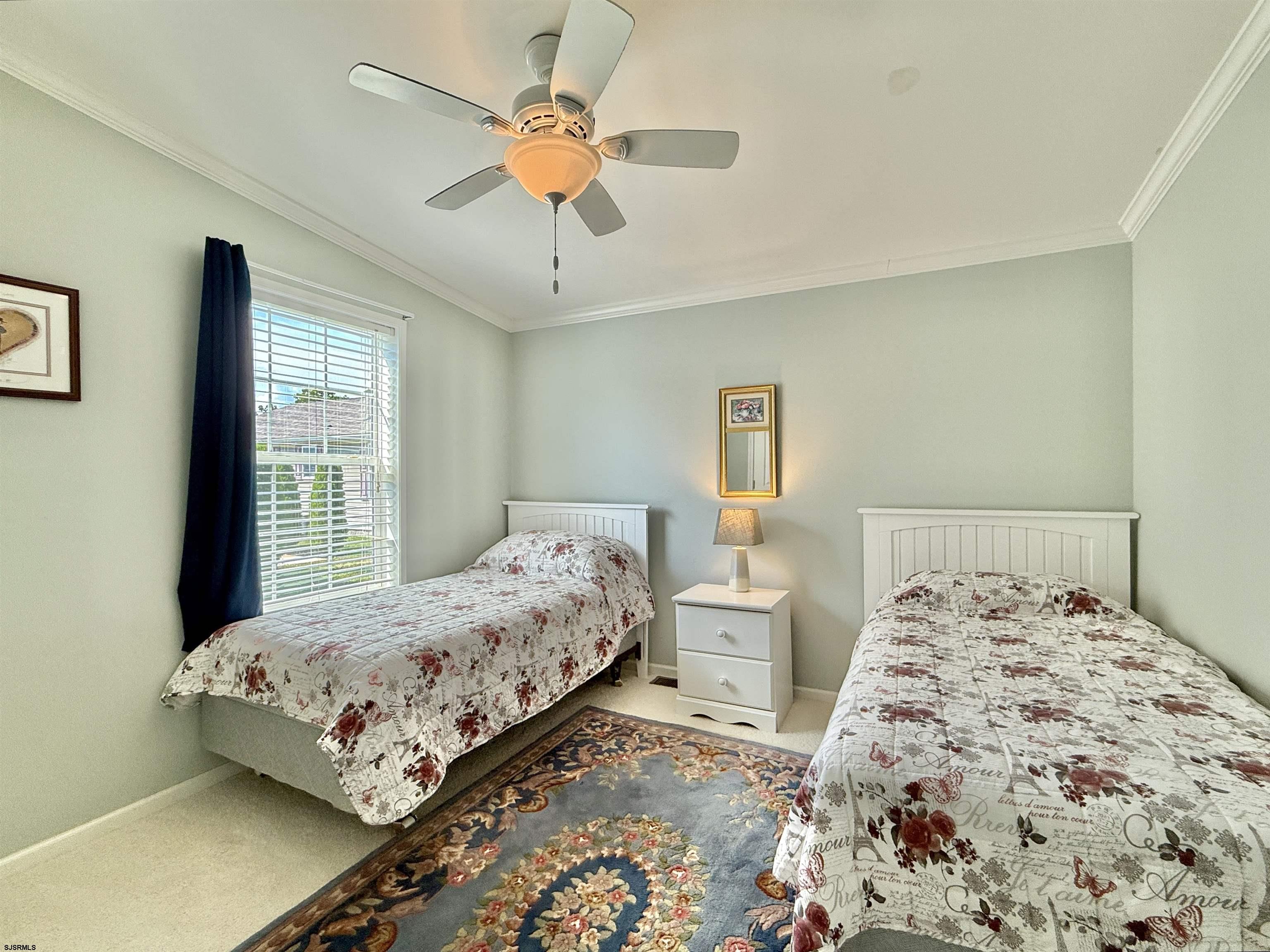 2058 South Shore Rd (route 9) Ocean View, NJ 08230 - Photo 27 of 36 a bedroom with a large bed and a chandelier