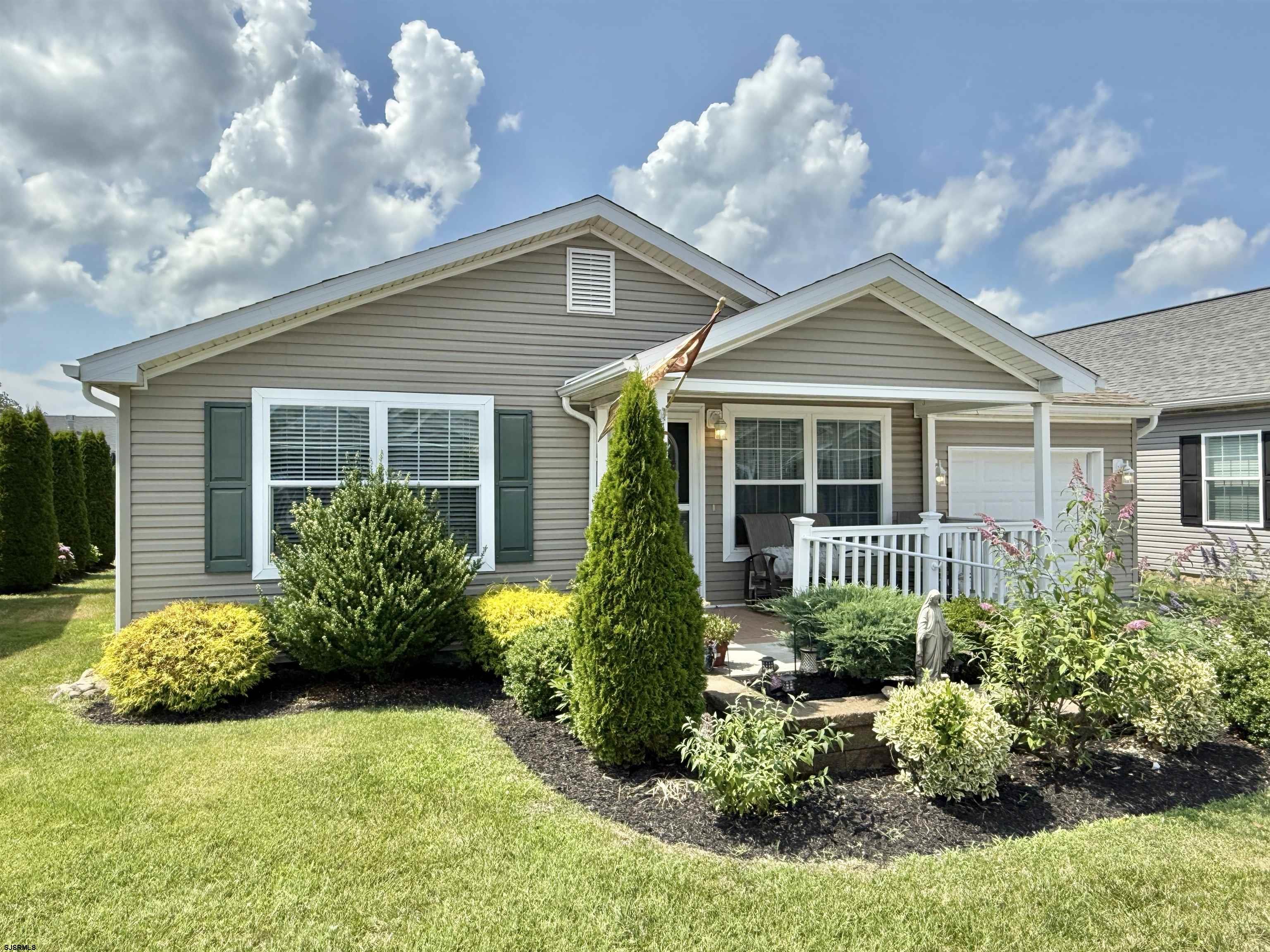 2058 South Shore Rd (route 9) Ocean View, NJ 08230 - Photo 7 of 36 a front view of a house with a yard and potted plants