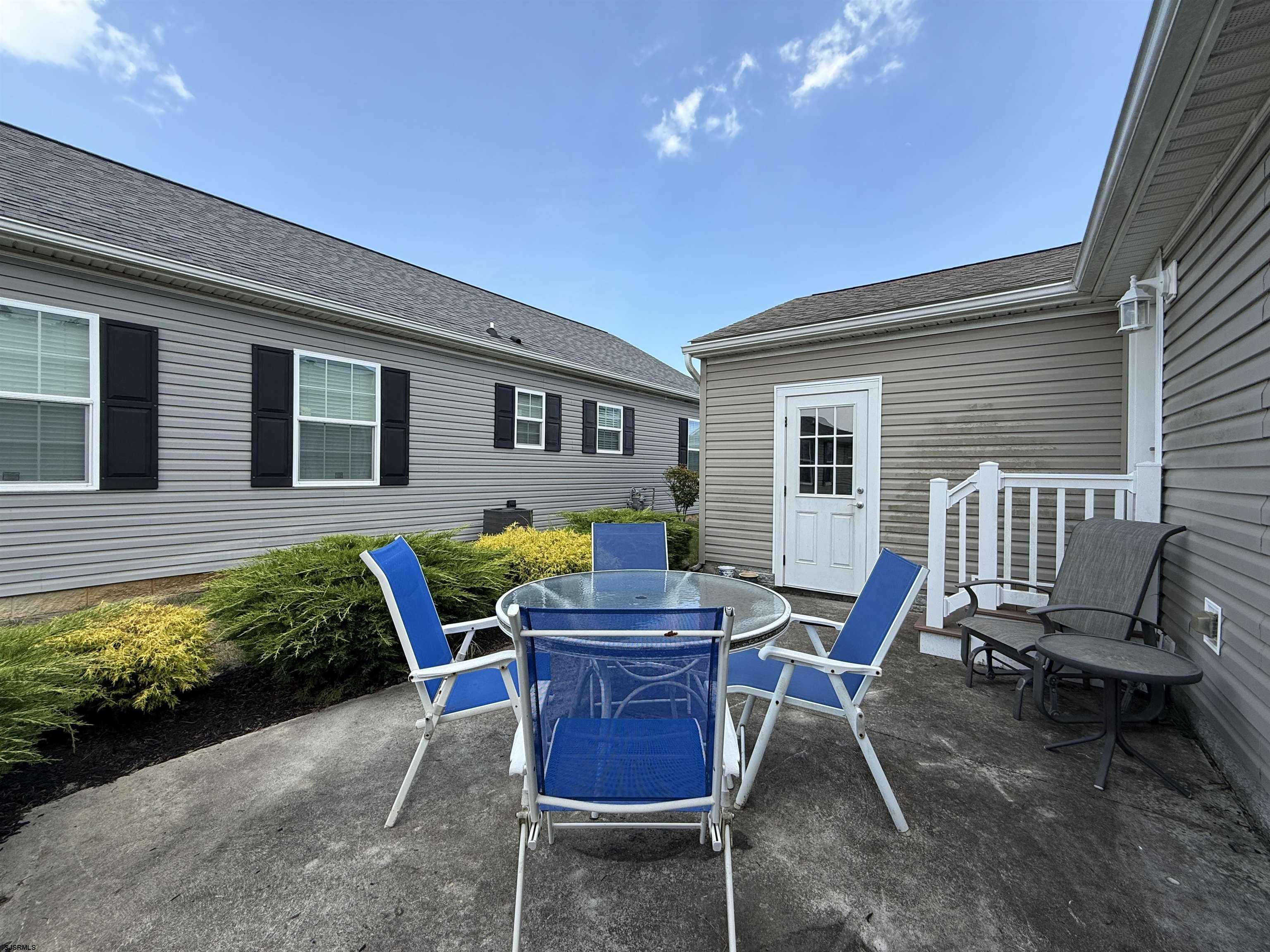 2058 South Shore Rd (route 9) Ocean View, NJ 08230 - Photo 10 of 36 a patio with table and chairs and potted plants