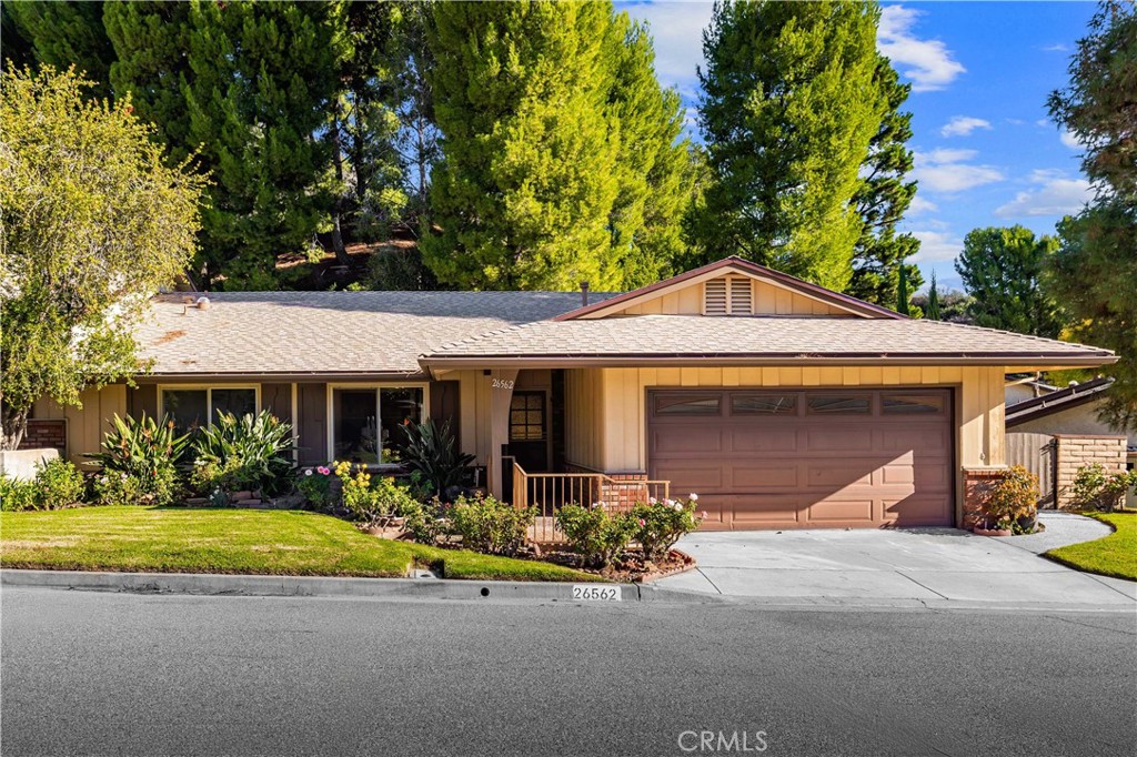 26562 Cardwick Court Newhall, CA 91321 - Photo 1 of 34 a front view of a house with a yard and potted plants