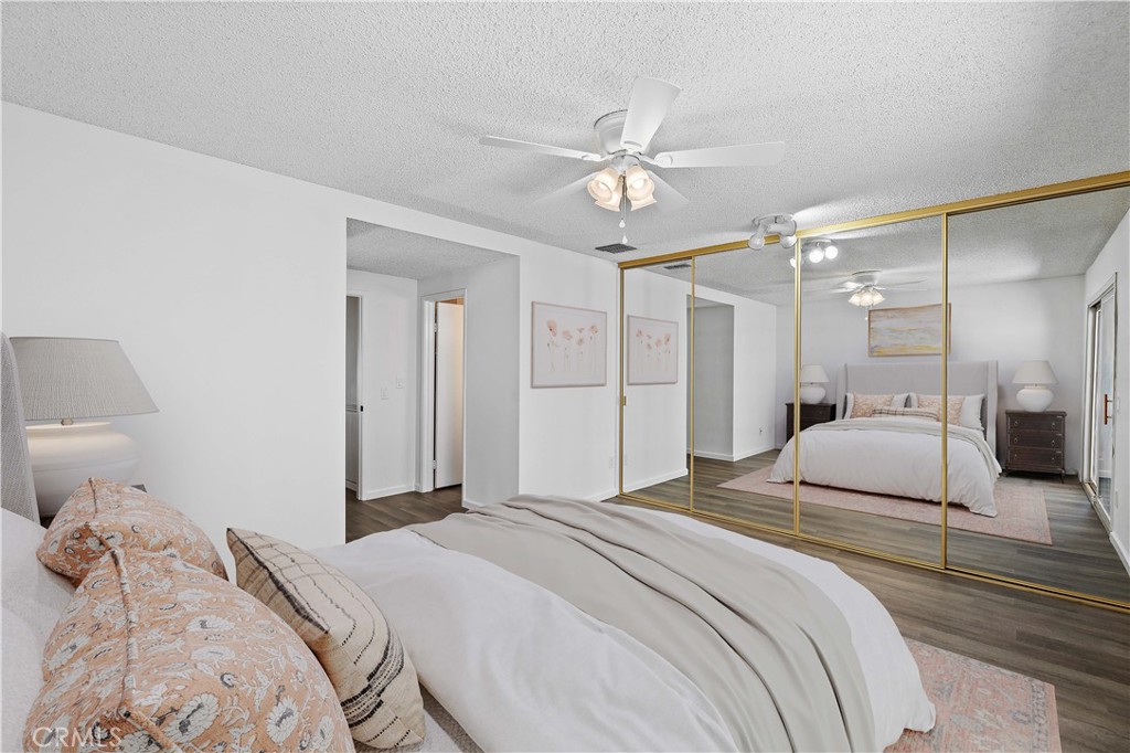 26562 Cardwick Court Newhall, CA 91321 - Photo 13 of 34 a bedroom with a bed and a chandelier