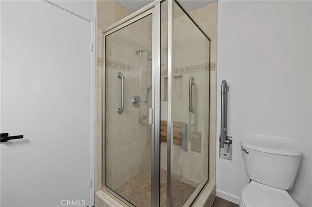 a bathroom with a shower and toilet