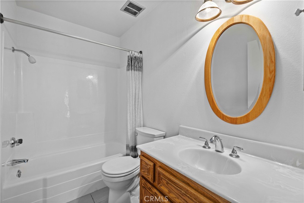 26562 Cardwick Court Newhall, CA 91321 - Photo 22 of 34 a bathroom with a sink a toilet and a mirror