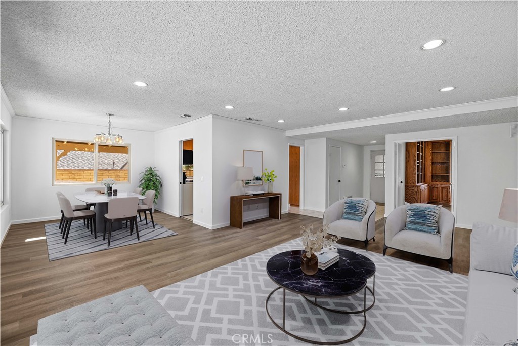26562 Cardwick Court Newhall, CA 91321 - Photo 3 of 34 a living room with furniture and a dining table with wooden floor