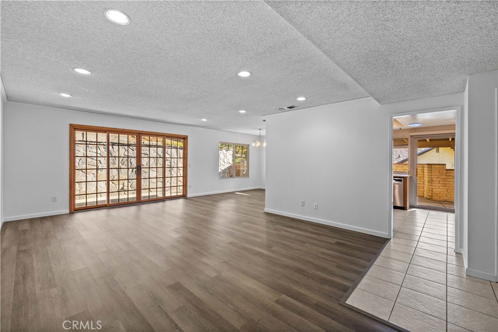 26562 Cardwick Court Newhall, CA 91321 - Photo 4 of 34 an empty room with wooden floor and windows