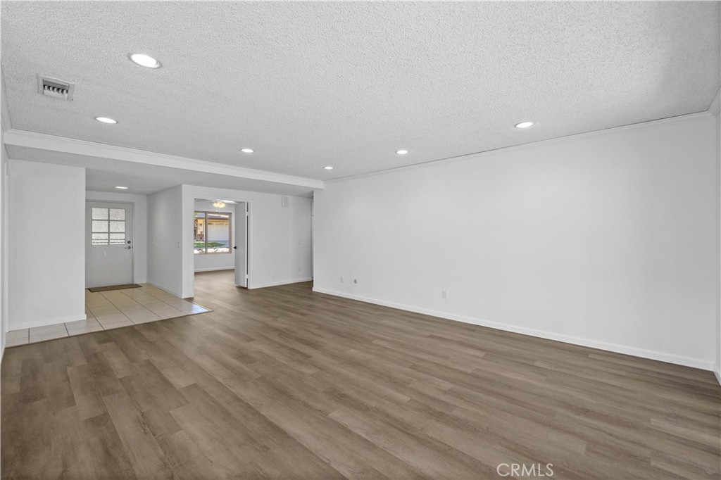 26562 Cardwick Court Newhall, CA 91321 - Photo 5 of 34 a view of an empty room with wooden floor and a window