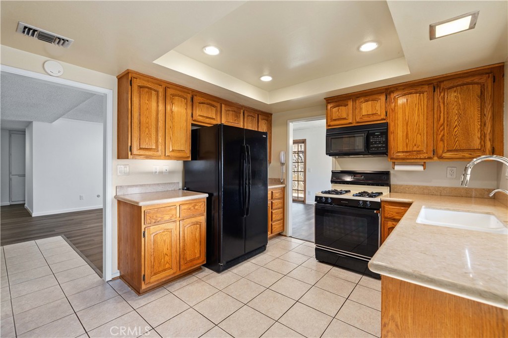 26562 Cardwick Court Newhall, CA 91321 - Photo 6 of 34 a kitchen with stainless steel appliances granite countertop a refrigerator and a sink