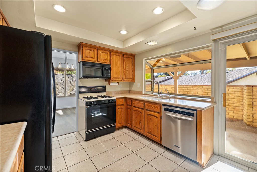 26562 Cardwick Court Newhall, CA 91321 - Photo 7 of 34 a kitchen with stainless steel appliances granite countertop a stove top oven
