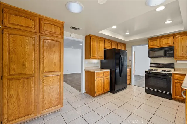 a kitchen with stainless steel appliances granite countertop a refrigerator and a stove