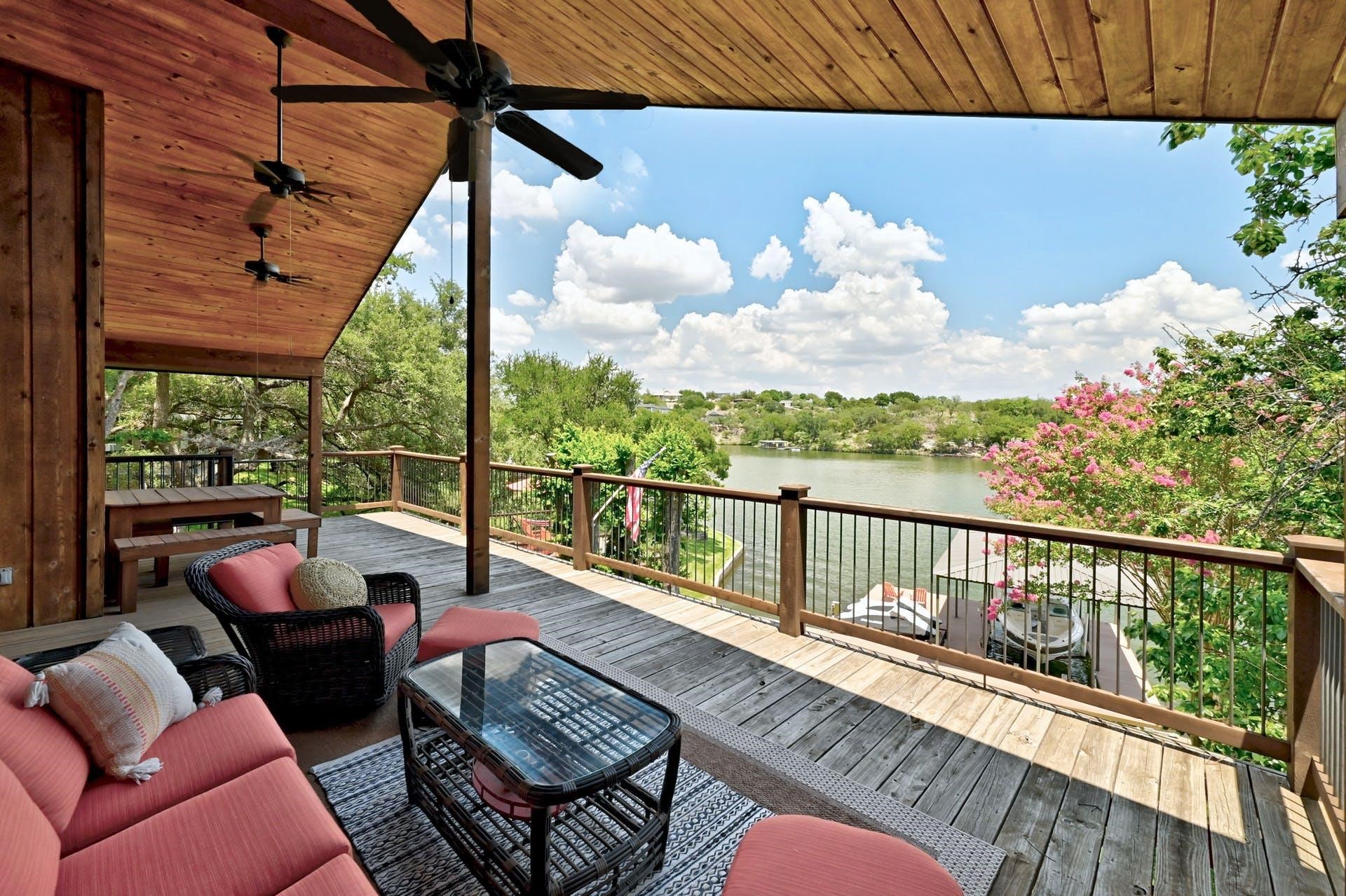 a balcony with wooden floor and outdoor seating