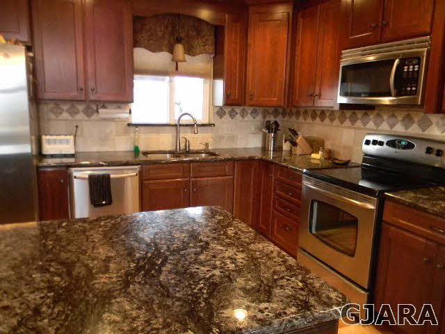 1712 North 3/10 Road Fruita, CO 81521 - Photo 11 of 34 a kitchen with a sink stove and microwave