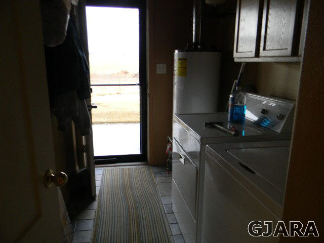 1712 North 3/10 Road Fruita, CO 81521 - Photo 12 of 34 a kitchen with a refrigerator and wooden floor