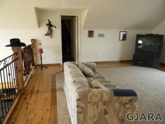 1712 North 3/10 Road Fruita, CO 81521 - Photo 14 of 34 a living room with furniture and a flat screen tv