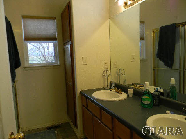 1712 North 3/10 Road Fruita, CO 81521 - Photo 18 of 34 a bathroom with a sink and a mirror