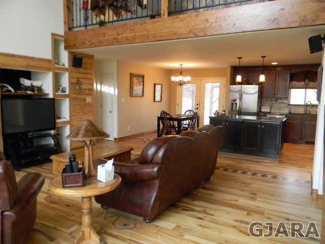 1712 North 3/10 Road Fruita, CO 81521 - Photo 2 of 34 a living room with furniture a flat screen tv and kitchen view