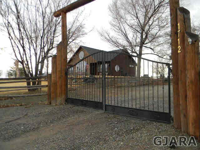 1712 North 3/10 Road Fruita, CO 81521 - Photo 24 of 34 a view of a house with a fence