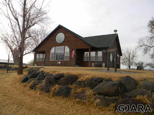 1712 North 3/10 Road Fruita, CO 81521 - Photo 25 of 34 a front view of a house with a yard