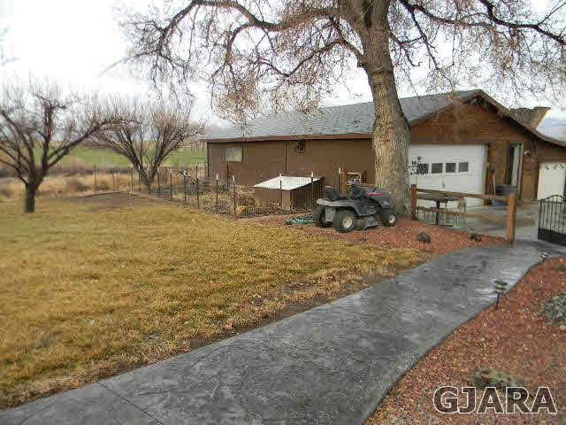 1712 North 3/10 Road Fruita, CO 81521 - Photo 30 of 34 a front view of a house with garden