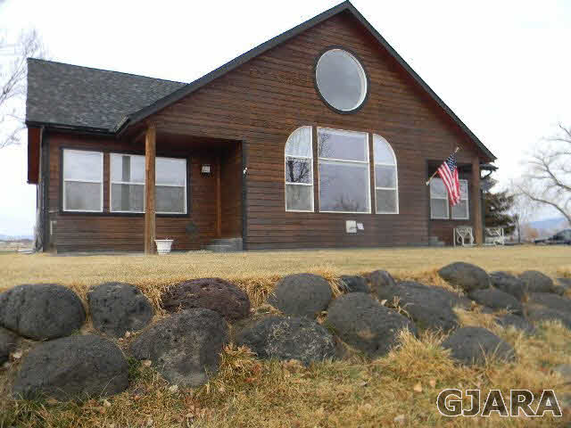 1712 North 3/10 Road Fruita, CO 81521 - Photo 31 of 34 a front view of a house with a yard