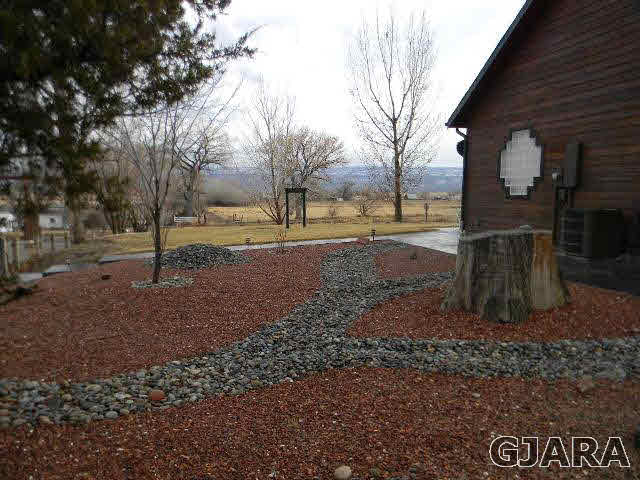 1712 North 3/10 Road Fruita, CO 81521 - Photo 33 of 34 a backyard of a house with lots of green space