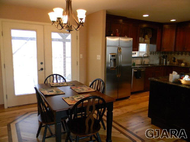 1712 North 3/10 Road Fruita, CO 81521 - Photo 8 of 34 a view of a dining room with furniture window and wooden floor
