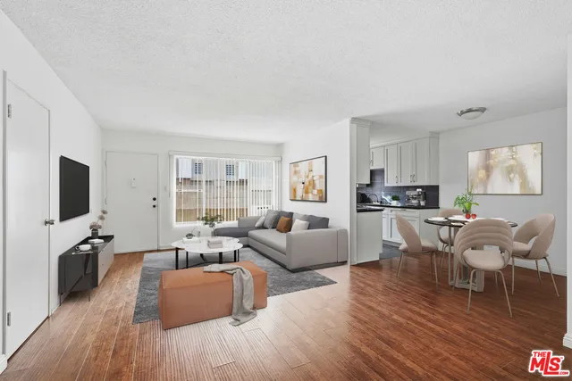 a living room with furniture flat screen tv and wooden floor