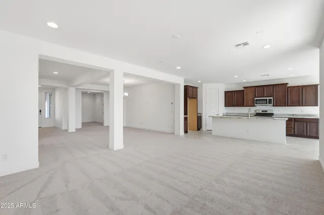 a view of a kitchen with a refrigerator and a counter top space