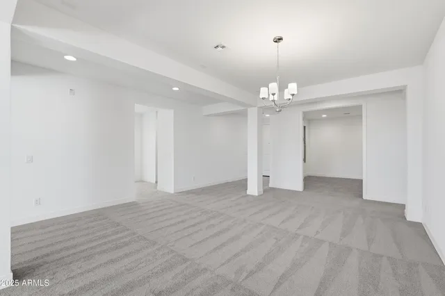 a view of a chandelier in big room and chandelier