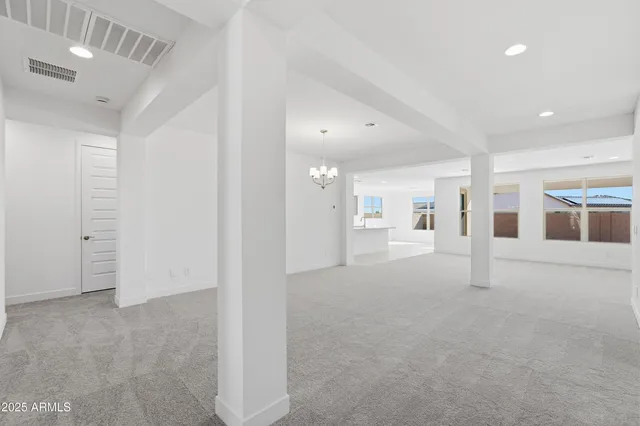 a view of a big room with closet and windows