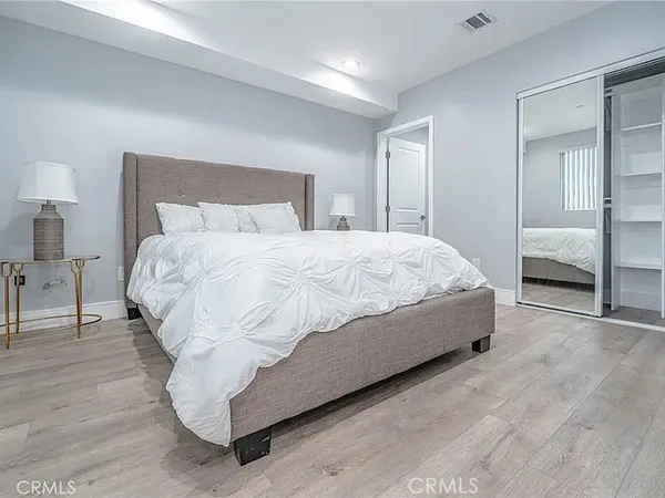 a bedroom with a bed and a lamp