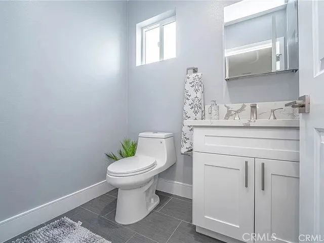 a bathroom with a sink toilet and a mirror