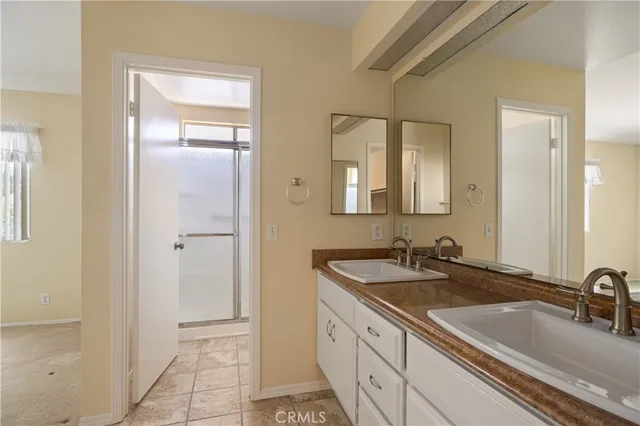 a bathroom with a double vanity sink and a mirror