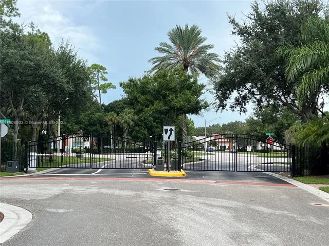 a view of a fountain with a tree in front of it