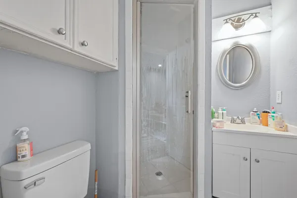 a bathroom with a sink a toilet and a mirror