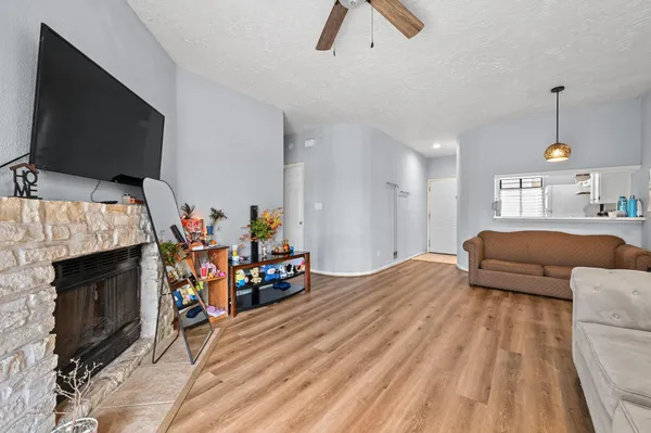 a bedroom with furniture a flat screen tv and a fireplace