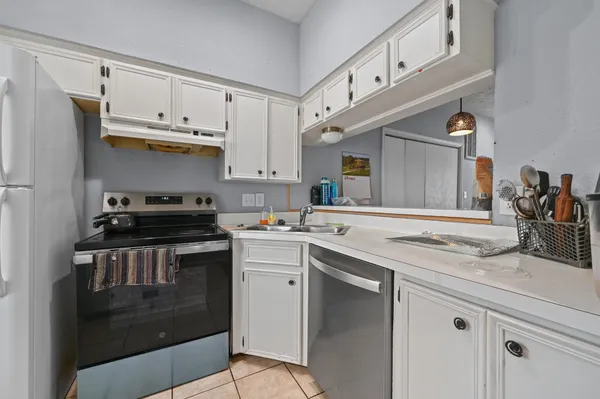 a kitchen with stainless steel appliances a sink stove and cabinets
