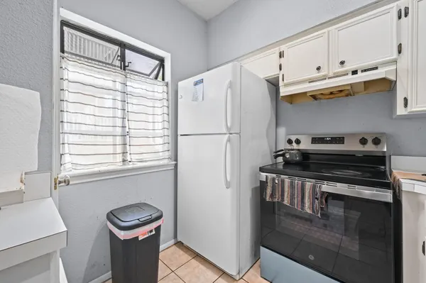a kitchen with a white cabinets and white appliances