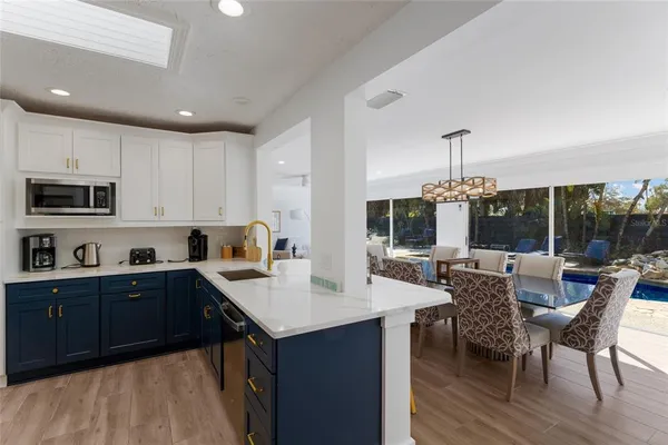 a kitchen with stainless steel appliances granite countertop a sink and cabinets
