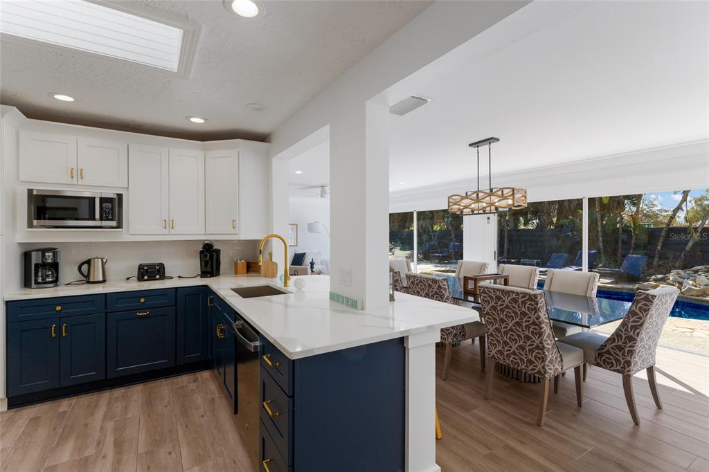 419 Clark Drive Holmes Beach, FL 34217 - Photo 13 of 53 a kitchen with sink cabinets and wooden floor