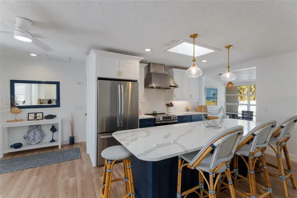 a kitchen with stainless steel appliances a sink and cabinets