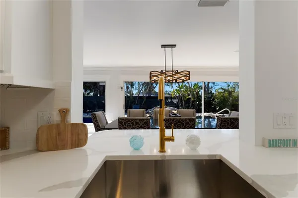 a large kitchen with stainless steel appliances kitchen island granite countertop a refrigerator a stove a sink dishwasher with a dining table and chairs