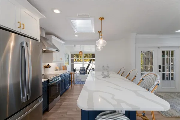 a large kitchen with a table and chairs