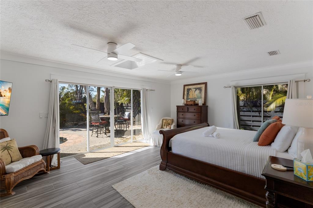 419 Clark Drive Holmes Beach, FL 34217 - Photo 22 of 53 a bedroom with a bed and wooden floor