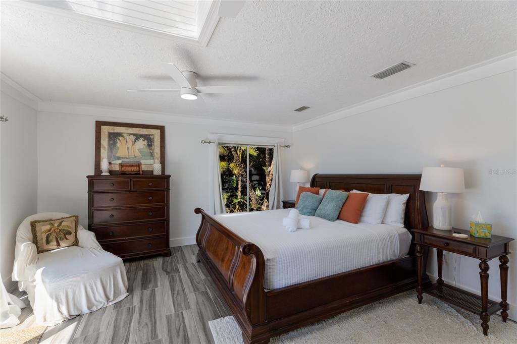 419 Clark Drive Holmes Beach, FL 34217 - Photo 23 of 53 a bedroom with a bed and wooden floor