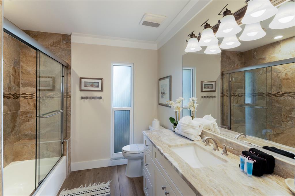 419 Clark Drive Holmes Beach, FL 34217 - Photo 30 of 53 a spacious bathroom with a double vanity sink toilet and shower